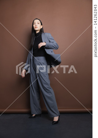 A woman in a stylish suit A woman in a stylish suit 141262843