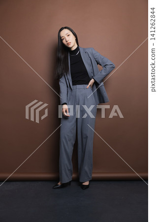 A woman in a stylish suit A woman in a stylish suit 141262844