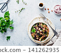 Vegetarian diet salad with beet, buckwheat grains, mushrooms, red onion and fresh herbs in bowl. Warm buckwheat and beetroot salad on gray concrete background. Top view. Copy space 141262935