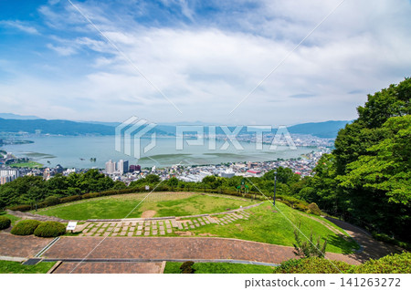 Stunning views of Lake Suwa and its surroundings from Tateishi Park during the summer season (Suwa City, Nagano Prefecture) Stunning views of Lake Suwa and its surroundings from Tateishi Park during the summer season (Suwa City, Nagano Prefecture) 141263272