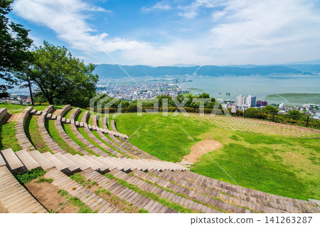 Stunning views of Lake Suwa and its surroundings from Tateishi Park during the summer season (Suwa City, Nagano Prefecture) Stunning views of Lake Suwa and its surroundings from Tateishi Park during the summer season (Suwa City, Nagano Prefecture) 141263287