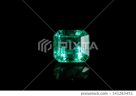 Macro mineral Emerald gemstone faceted on black background Macro mineral Emerald gemstone faceted on black background 141263451