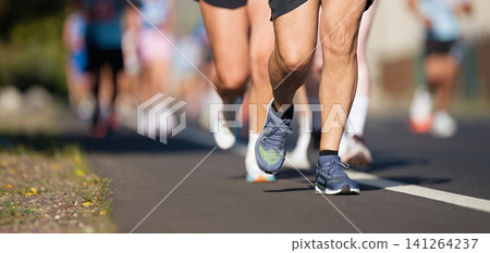 Marathon running race, people feet on city road, runners run urban marathon in the the city Marathon running race, people feet on city road, runners run urban marathon in the the city 141264237