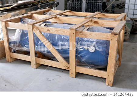 New blue industrial pressure receiver tank packed in protective wooden crate box crate New blue industrial pressure receiver tank packed in protective wooden crate box crate 141264482