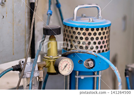 Industrial pneumatic pressure regulator with manometer gauge on factory machinery system Industrial pneumatic pressure regulator with manometer gauge on factory machinery system 141264500