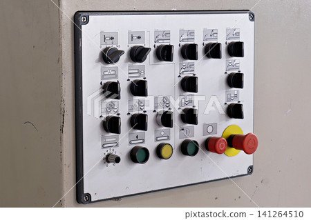 Industrial control console panel with multiple black rotary switches and emergency button Industrial control console panel with multiple black rotary switches and emergency button 141264510