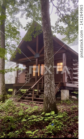 A log cabin in a forest villa area during the rainy season A log cabin in a forest villa area during the rainy season 141264965