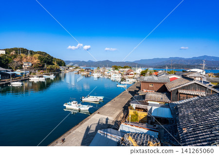 [Important Preservation District for Groups of Traditional Buildings] Dewajima Island: Early spring view of the west breakwater and fishing port from Tasukaru Tower 2, Mugi-cho, Kaifu-gun, Tokushima Prefecture 141265060