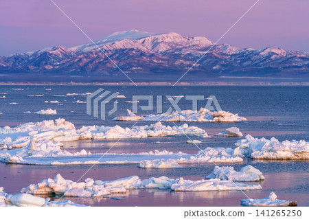 A stunning winter landscape of Kunashir Island and drift ice bathed in the morning glow, as seen from the Notsuke Peninsula in Hokkaido. A stunning winter landscape of Kunashir Island and drift ice bathed in the morning glow, as seen from the Notsuke Peninsula in Hokkaido. 141265250