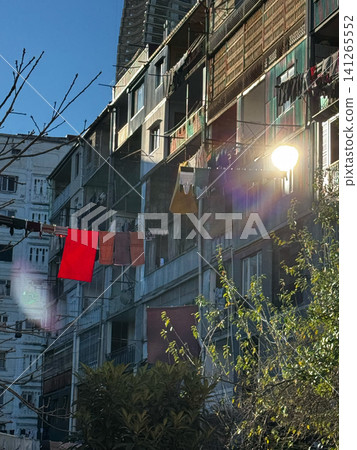 Sun flare over balconies with laundry hanging on vintage residential buildings in Batumi, Georgia Sun flare over balconies with laundry hanging on vintage residential buildings in Batumi, Georgia 141265552
