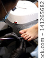 A woman's feet during a pedicure. Woman getting pedicure in beauty salon, closeup. A pedicurist working at a beauty salon. Manicure services. Nail art. Beauty salon concept: pedicures. A woman's feet during a pedicure. Woman getting pedicure in beauty salon, closeup. A pedicurist working at a beauty salon. Manicure services. Nail art. Beauty salon concept: pedicures. 141265682