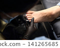 A woman's feet during a pedicure. Woman getting pedicure in beauty salon, closeup. A pedicurist working at a beauty salon. Manicure services. Nail art. Beauty salon concept: pedicures. A woman's feet during a pedicure. Woman getting pedicure in beauty salon, closeup. A pedicurist working at a beauty salon. Manicure services. Nail art. Beauty salon concept: pedicures. 141265685