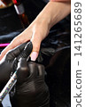 A woman's hand during a manicure. A woman getting a manicure. A manicurist is doing a client's nails at a nail salon. Manicure services. Nail art. Beauty salon. A woman's hand during a manicure. A woman getting a manicure. A manicurist is doing a client's nails at a nail salon. Manicure services. Nail art. Beauty salon. 141265689
