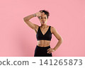 Tired young Black athletic woman wiping sweat from her forehead after exercise 141265873
