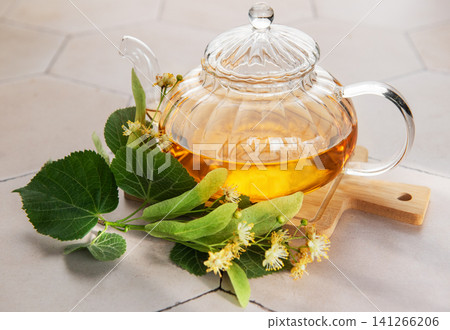 Linden tea brewing in glass teapot with herbs Linden tea brewing in glass teapot with herbs 141266206