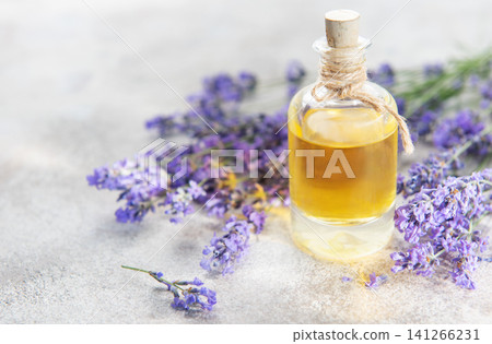 Lavender flowers surrounding a bottle of natural essential oil 141266231