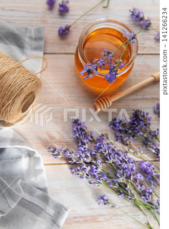 Honey jar with fresh lavender flowers and rustic elements Honey jar with fresh lavender flowers and rustic elements 141266234