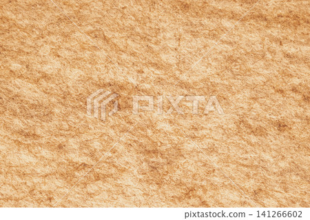 Horizontal close up of a rustic warm beige brown felt fabric material showing detailed dense organic pressed wool fibers on a cozy textured backdrop surface 141266602
