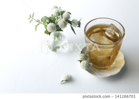 White globe amaranth and iced tea: A refreshing summer table photo. Copy space available. White globe amaranth and iced tea: A refreshing summer table photo. Copy space available. 141266701
