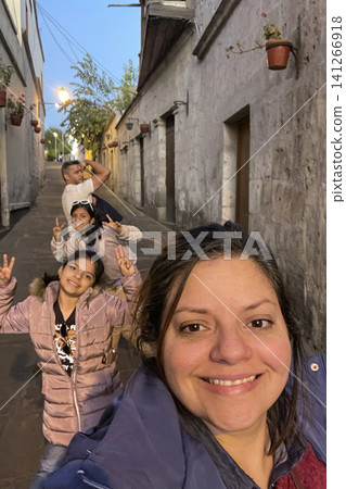 Family posing in narrow colonial street at twilight. UGC Family posing in narrow colonial street at twilight. UGC 141266918