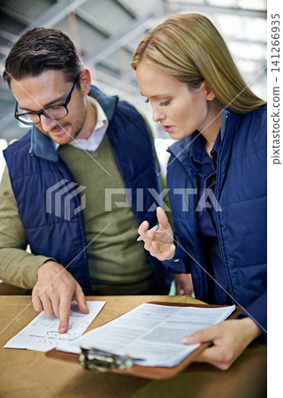 Business people, reading and checking inventory with storage in supply chain at warehouse. Logistic coworkers, team or employees looking at documents, paperwork or clipboard for distribution factory Business people, reading and checking inventory with storage in supply chain at warehouse. Logistic coworkers, team or employees looking at documents, paperwork or clipboard for distribution factory 141266935