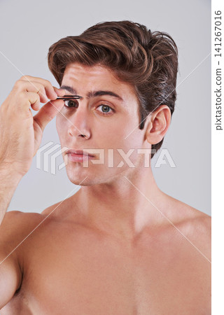 Tweezer, eyebrow and man on gray background for beauty, hair removal and facial treatment in studio. Skincare, dermatology and isolated person with cosmetics tools for health, grooming and hygiene Tweezer, eyebrow and man on gray background for beauty, hair removal and facial treatment in studio. Skincare, dermatology and isolated person with cosmetics tools for health, grooming and hygiene 141267016