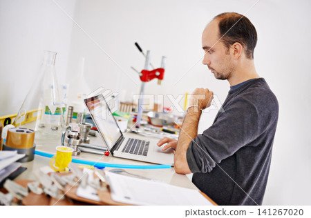 Man, laptop and equipment in factory, brewery and thinking with ideas, research and development. Person, computer and vision with info on web for alcohol, craft beer and tools on desk in warehouse Man, laptop and equipment in factory, brewery and thinking with ideas, research and development. Person, computer and vision with info on web for alcohol, craft beer and tools on desk in warehouse 141267020