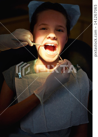 Dental mirror, hands or girl face with dentist for mouth exam, tooth cavity or gum disease, bacteria or search. Oral, wellness or doctor with light, equipment or pediatric dentistry tool or cleaning Dental mirror, hands or girl face with dentist for mouth exam, tooth cavity or gum disease, bacteria or search. Oral, wellness or doctor with light, equipment or pediatric dentistry tool or cleaning 141267065