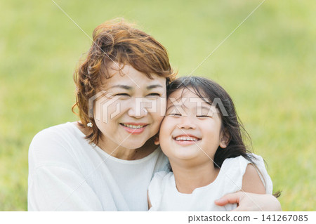 A mother and daughter smiling. A mother and daughter smiling. 141267085