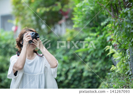 A woman holding a camera A woman holding a camera 141267093