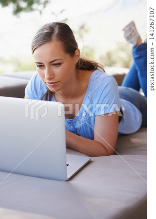 House, remote work and woman on sofa with laptop for working from home, freelance job and career. Business, startup and person on computer for typing email, planning or internet research on website House, remote work and woman on sofa with laptop for working from home, freelance job and career. Business, startup and person on computer for typing email, planning or internet research on website 141267107