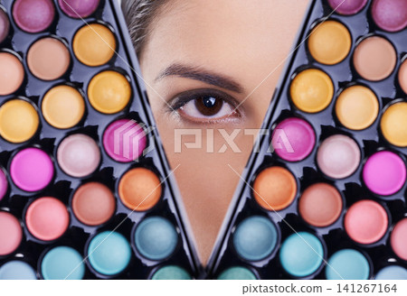 Beauty, makeup palette and eye of woman in studio for cosmetics, powder and foundation on background. Closeup, skincare and portrait of model with cosmetology product, facial glow and eyeshadow Beauty, makeup palette and eye of woman in studio for cosmetics, powder and foundation on background. Closeup, skincare and portrait of model with cosmetology product, facial glow and eyeshadow 141267164