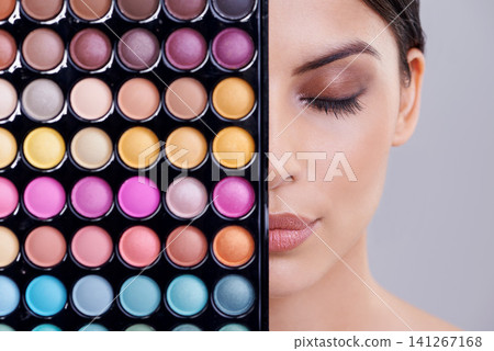 Eyeshadow, portrait and woman in studio with makeup palette for cosmetics, powder and foundation on gray background. Closeup, beauty and model with cosmetology product, facial glow and skincare Eyeshadow, portrait and woman in studio with makeup palette for cosmetics, powder and foundation on gray background. Closeup, beauty and model with cosmetology product, facial glow and skincare 141267168