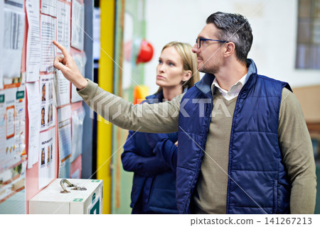 People, planning and checking schedule with board in warehouse with calendar for order details. Man, woman and together with checklist or clipboard for supplier information and inventory updates People, planning and checking schedule with board in warehouse with calendar for order details. Man, woman and together with checklist or clipboard for supplier information and inventory updates 141267213