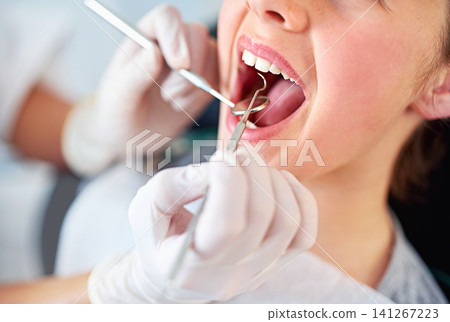 Girl, kid and mouth inspection at dentist with healthcare tool, consultation or dental mirror for oral health. Professional, child patient or glove hand for teeth cleaning, gingivitis or medical care Girl, kid and mouth inspection at dentist with healthcare tool, consultation or dental mirror for oral health. Professional, child patient or glove hand for teeth cleaning, gingivitis or medical care 141267223