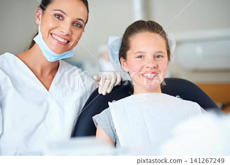 Portrait of dentist and child for consulting, dental service and teeth whitening for wellness in clinic. Healthcare, dentistry and happy woman and girl hygiene, oral care and medical consultation Portrait of dentist and child for consulting, dental service and teeth whitening for wellness in clinic. Healthcare, dentistry and happy woman and girl hygiene, oral care and medical consultation 141267249