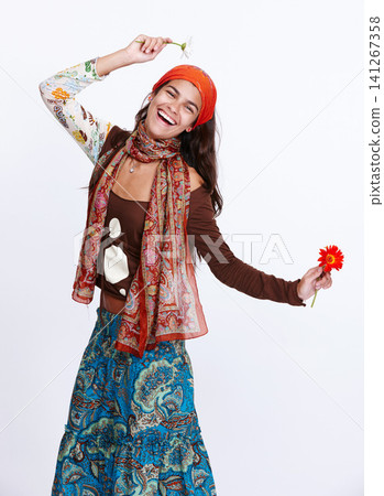 Woman, fashion and portrait in studio for gypsy and dress for creativity and bohemian style for trend. Lady, model and flowers for excited with skirt for aesthetic and clothes with pattern and colour Woman, fashion and portrait in studio for gypsy and dress for creativity and bohemian style for trend. Lady, model and flowers for excited with skirt for aesthetic and clothes with pattern and colour 141267358