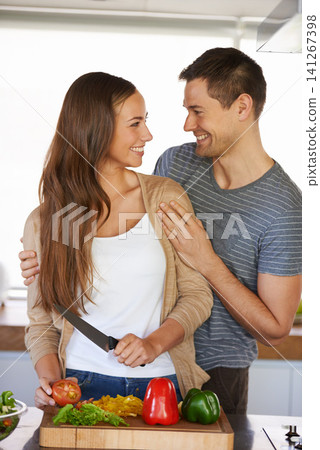 Couple, kitchen and vegetables for nutrition or chop, diet and food preparation for cooking. Happy people, home and fresh produce for salad or vegan dinner, organic ingredients and touch for bonding Couple, kitchen and vegetables for nutrition or chop, diet and food preparation for cooking. Happy people, home and fresh produce for salad or vegan dinner, organic ingredients and touch for bonding 141267398