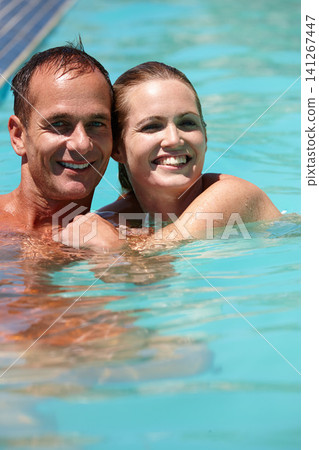 Couple, portrait and hug with love in swimming pool for connection, care and relax on vacation for honeymoon. Man, woman and embrace in water for smile, bonding or summer holiday at resort in Naples Couple, portrait and hug with love in swimming pool for connection, care and relax on vacation for honeymoon. Man, woman and embrace in water for smile, bonding or summer holiday at resort in Naples 141267447