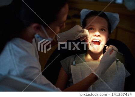 Dental, mirror or girl with dentist for mouth exam, tooth cavity or gum disease, bacteria or search. Oral care, wellness or doctor with light, equipment or tool for pediatric dentistry or cleaning Dental, mirror or girl with dentist for mouth exam, tooth cavity or gum disease, bacteria or search. Oral care, wellness or doctor with light, equipment or tool for pediatric dentistry or cleaning 141267454