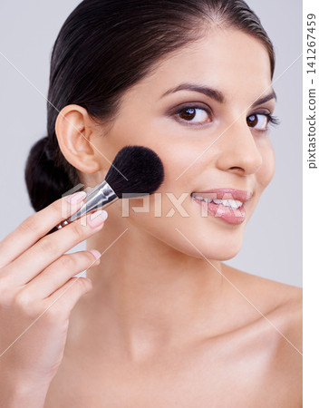 Woman, portrait and makeup brush in studio for beauty blush, cosmetics or grey background. Female person, facial contour and treatment transformation for makeover wellness, mockup space or routine Woman, portrait and makeup brush in studio for beauty blush, cosmetics or grey background. Female person, facial contour and treatment transformation for makeover wellness, mockup space or routine 141267459