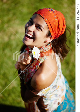 Bohemian, portrait and woman in nature, smile and clothes with aesthetic of fashion and above. Peace, female person and girl with flower in field, summer and fabric of outfit for artist for culture Bohemian, portrait and woman in nature, smile and clothes with aesthetic of fashion and above. Peace, female person and girl with flower in field, summer and fabric of outfit for artist for culture 141267487
