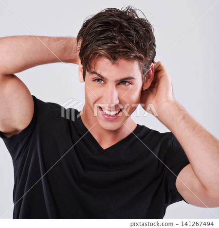 Handsome man, fashion and style with hair, tshirt or grooming on a gray studio background. Attractive male person, caucasian or young model with trendy hairstyle, casual clothing or barber treatment Handsome man, fashion and style with hair, tshirt or grooming on a gray studio background. Attractive male person, caucasian or young model with trendy hairstyle, casual clothing or barber treatment 141267494