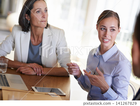 Teamwork, women or business people in meeting, conversation or discussion in boardroom office. Listening, colleagues talking or female employees planning strategy, feedback report or group project 141267829