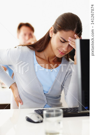 Woman, back pain and stress in office with computer at work, migraine or headache at workplace. Female employee and tension at desk in workroom with technology, discomfort or injury and difficulty 141267874