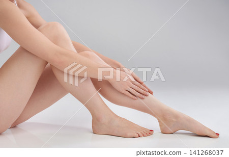 Woman, leg or hand in epilation, skincare or cosmetology as luxury, wellness or self care in studio. Female person, touch or smooth skin in satisfaction of hair removal, dermatology or hygiene result Woman, leg or hand in epilation, skincare or cosmetology as luxury, wellness or self care in studio. Female person, touch or smooth skin in satisfaction of hair removal, dermatology or hygiene result 141268037
