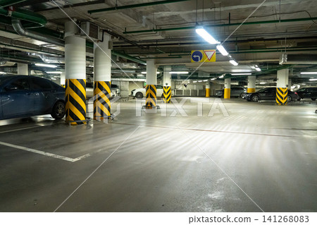Spacious and Modern Underground Parking Garage Featuring Well-Marked Lanes and Designated Spaces for Vehicles in a Clean, Well-Maintained Environment Spacious and Modern Underground Parking Garage Featuring Well-Marked Lanes and Designated Spaces for Vehicles in a Clean, Well-Maintained Environment 141268083