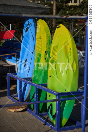 Colorful kayaks on a rack at Essaouira beach reflecting Moroccan coastal culture and tourist impressions Colorful kayaks on a rack at Essaouira beach reflecting Moroccan coastal culture and tourist impressions 141268502