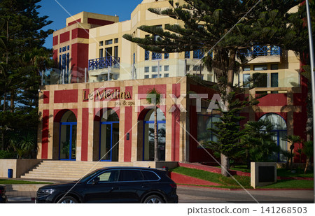 Le Medina sea and spa hotel in Essaouira Morocco with red facade and palm trees Le Medina sea and spa hotel in Essaouira Morocco with red facade and palm trees 141268503
