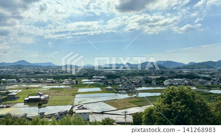Japanese Landscapes: Rice fields and mountain ranges stretching out under a blue sky Japanese Landscapes: Rice fields and mountain ranges stretching out under a blue sky 141268983